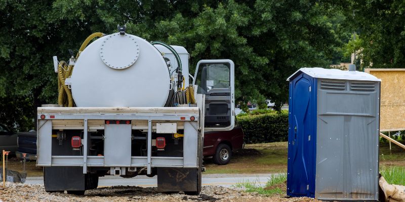 PORTA POTTY RENTALS NEAR ME | OUR TRUCK AT A CONSTRUCTION SITE IS SERVICING A PORTA POTTY RENTAL